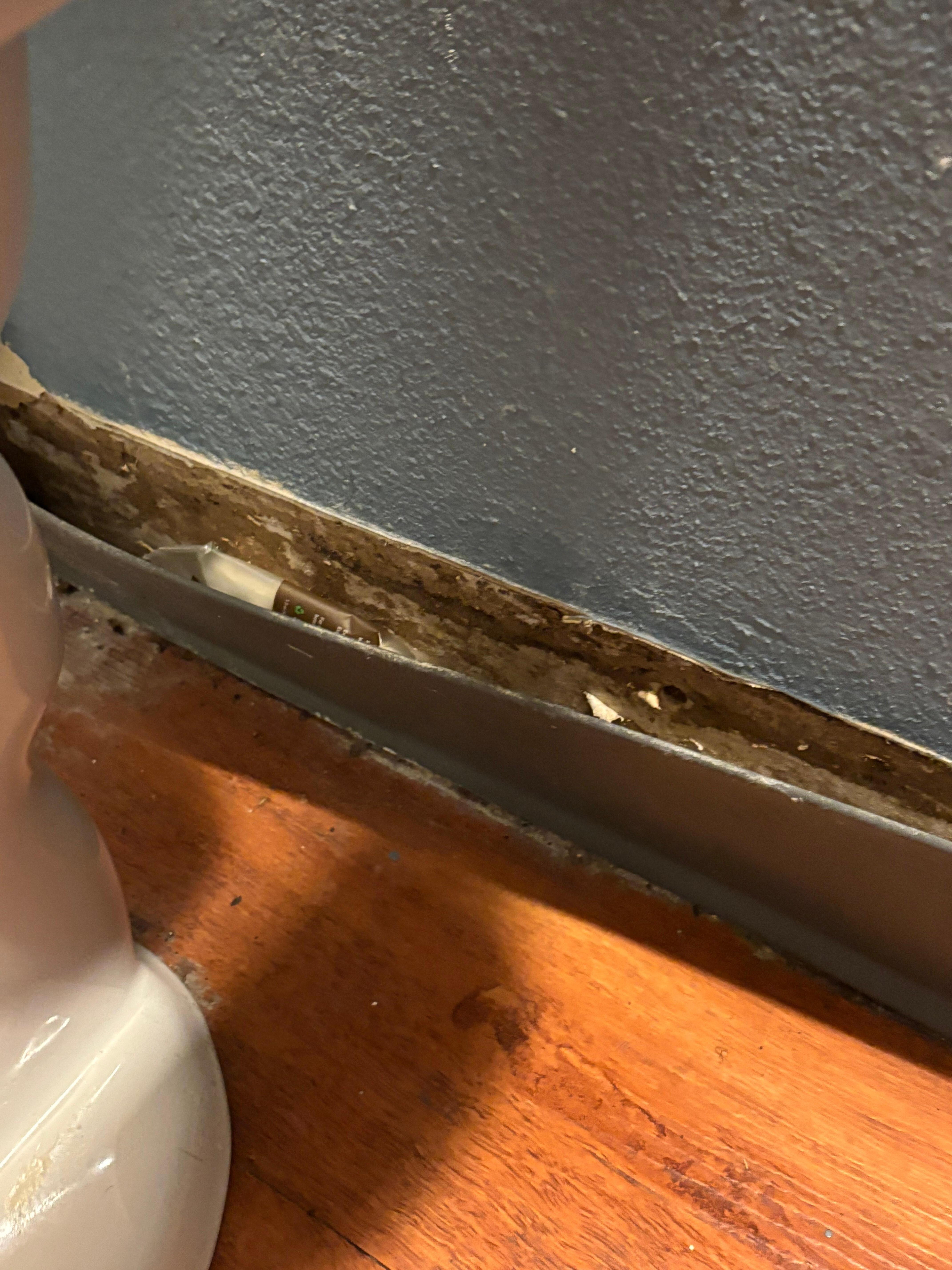 Behind toilet