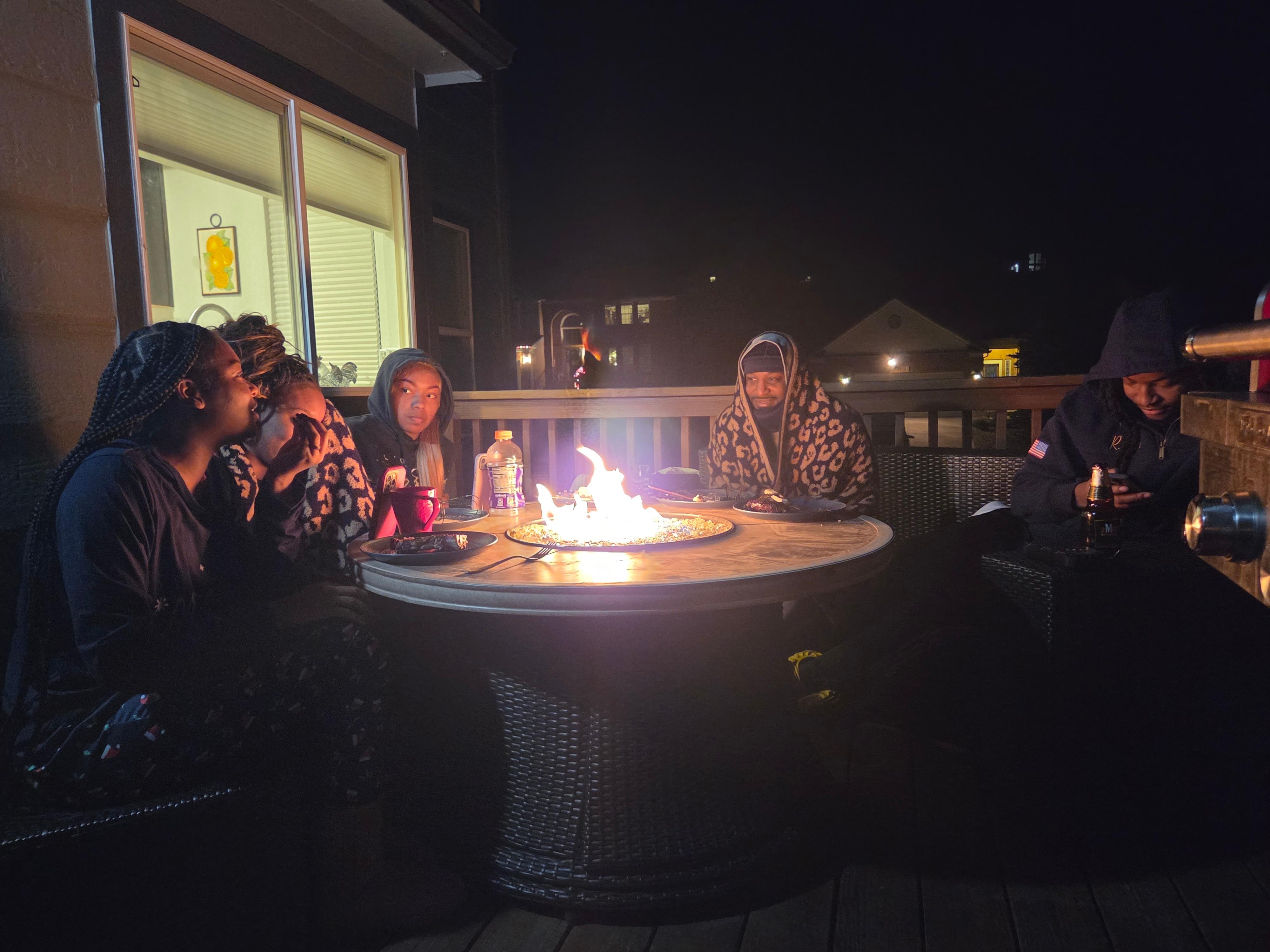 Roasting marshmallows and enjoying one another.