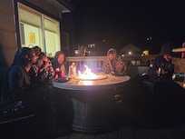 Roasting marshmallows and enjoying one another.