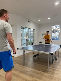 Ping pong at the clubhouse with a weight room