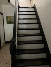 First set of stairs. Second set are behind the top door.