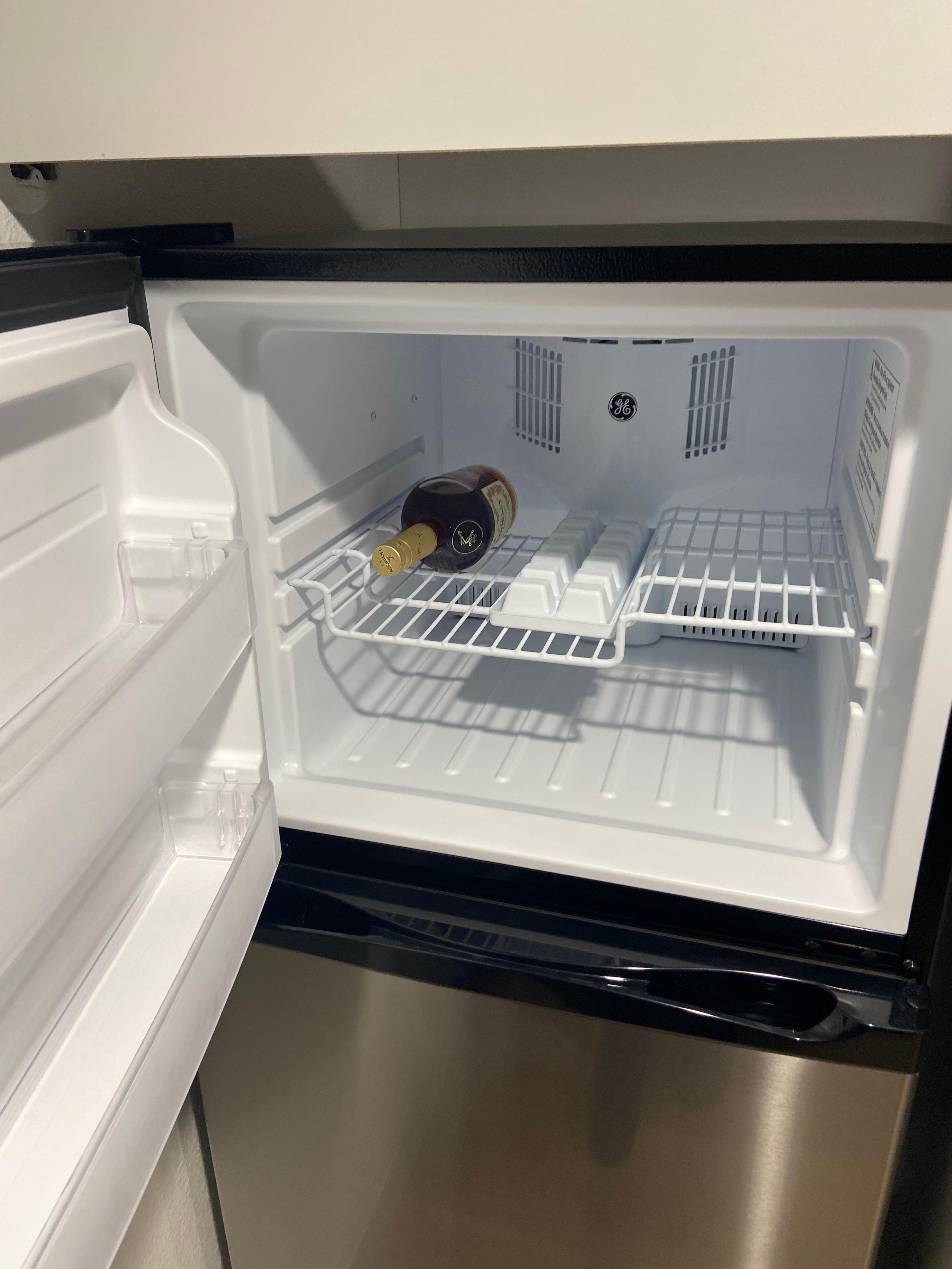 Refrigerator and microwave and stovetop in the room. 