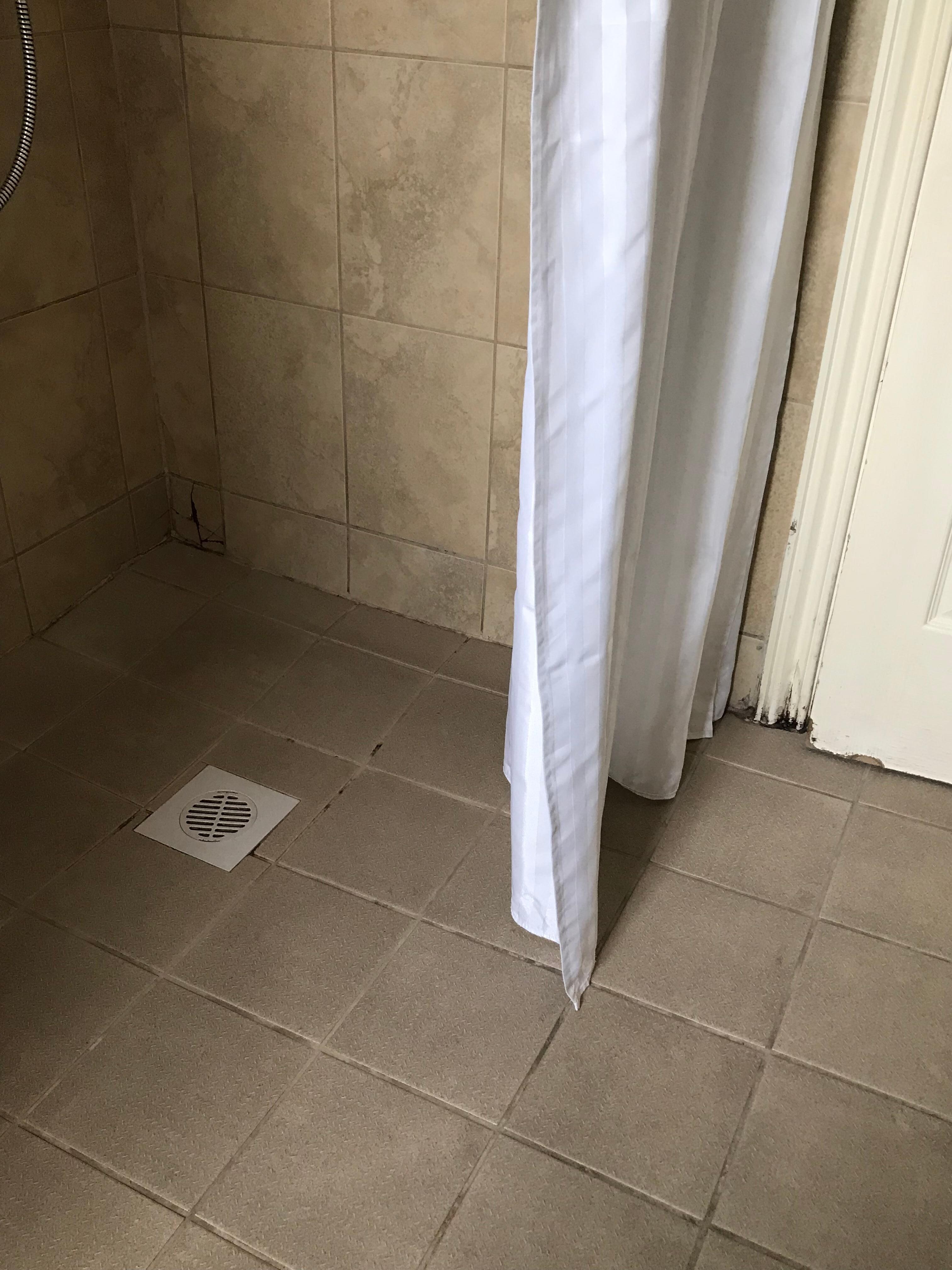 Timber door frame damaged from water from shower