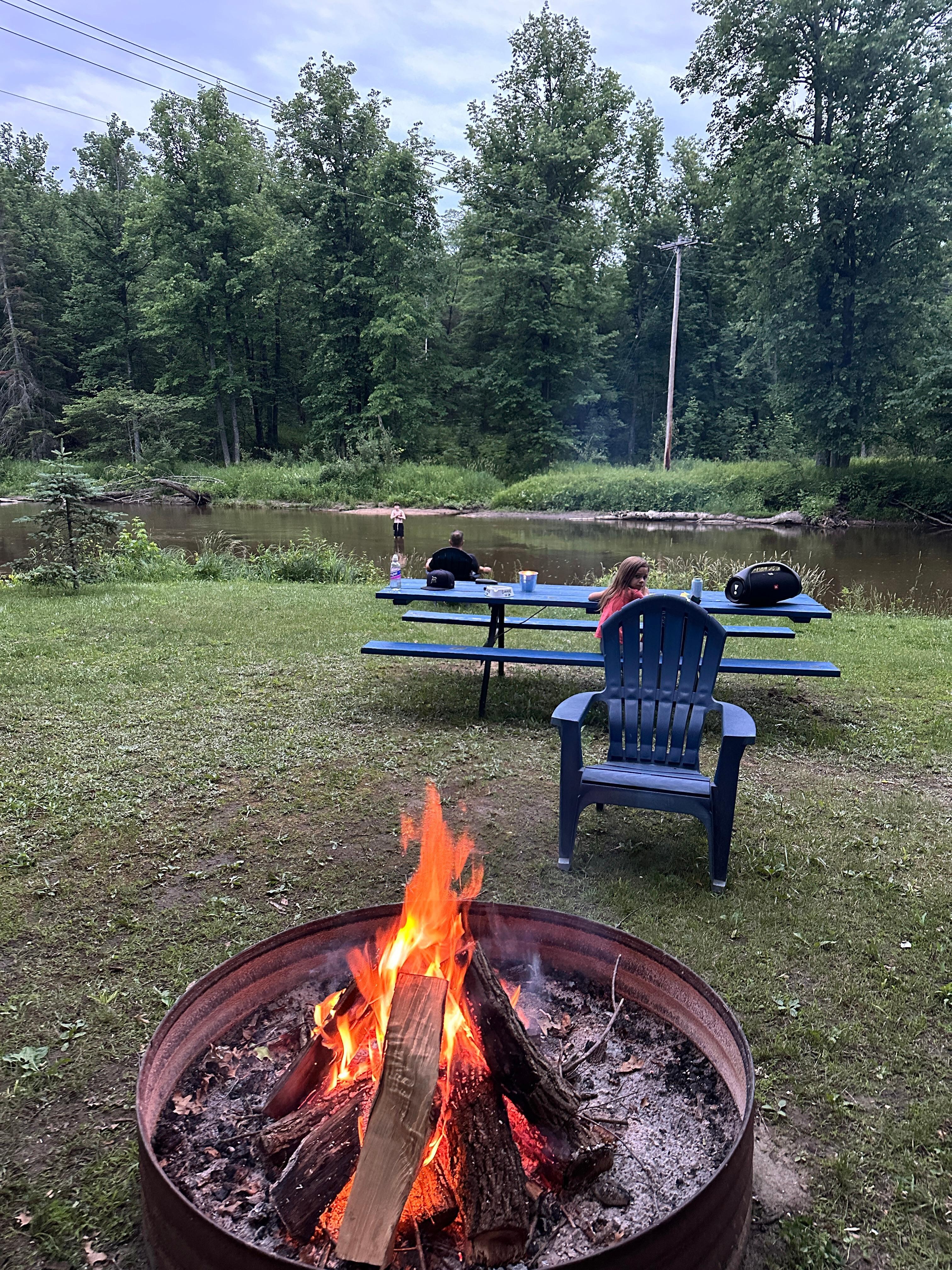Second Bonfire pit and picnic table located next to river. 