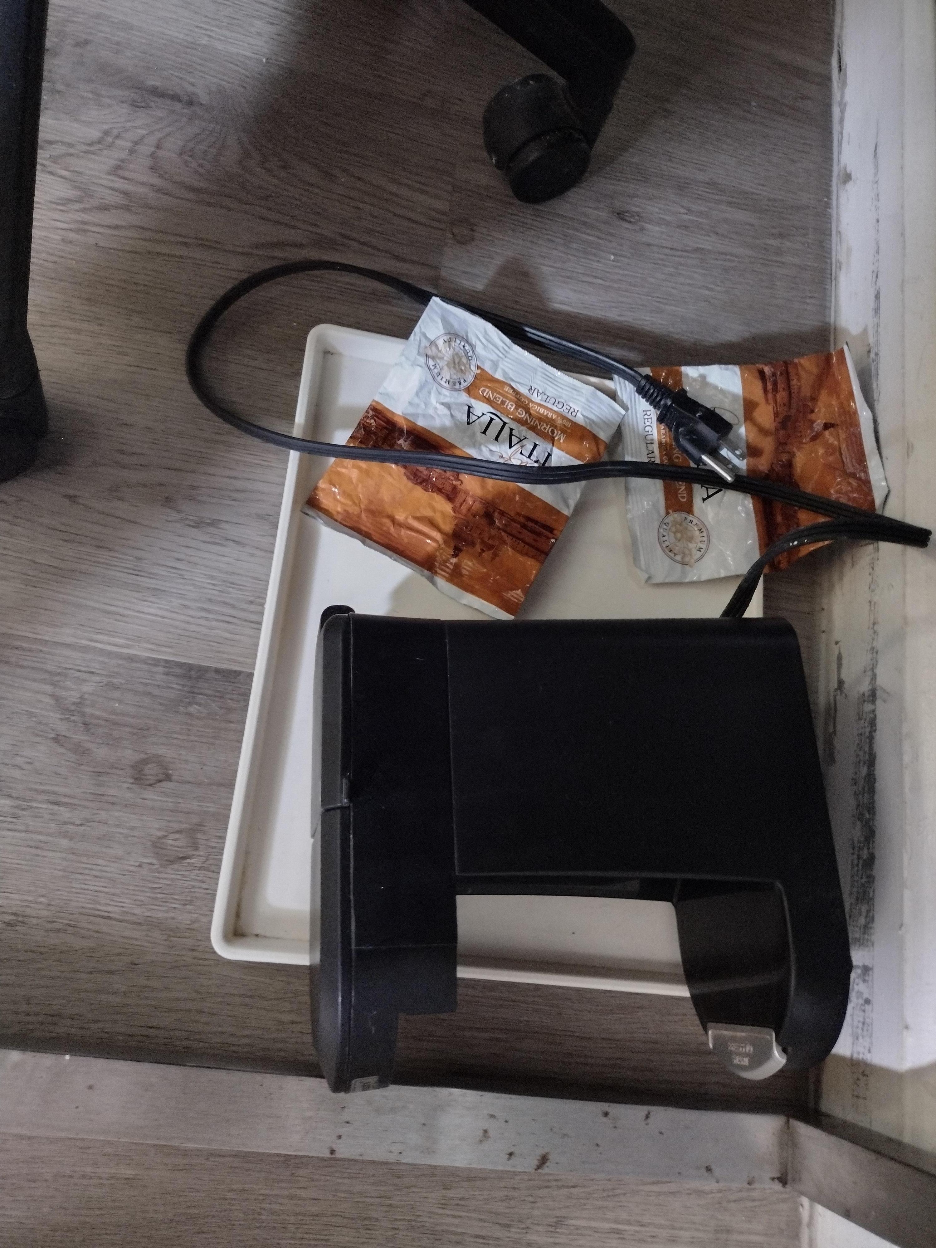 Coffee maker and packets of coffee but NO coffee pot, cup, spoon, cream, sugar