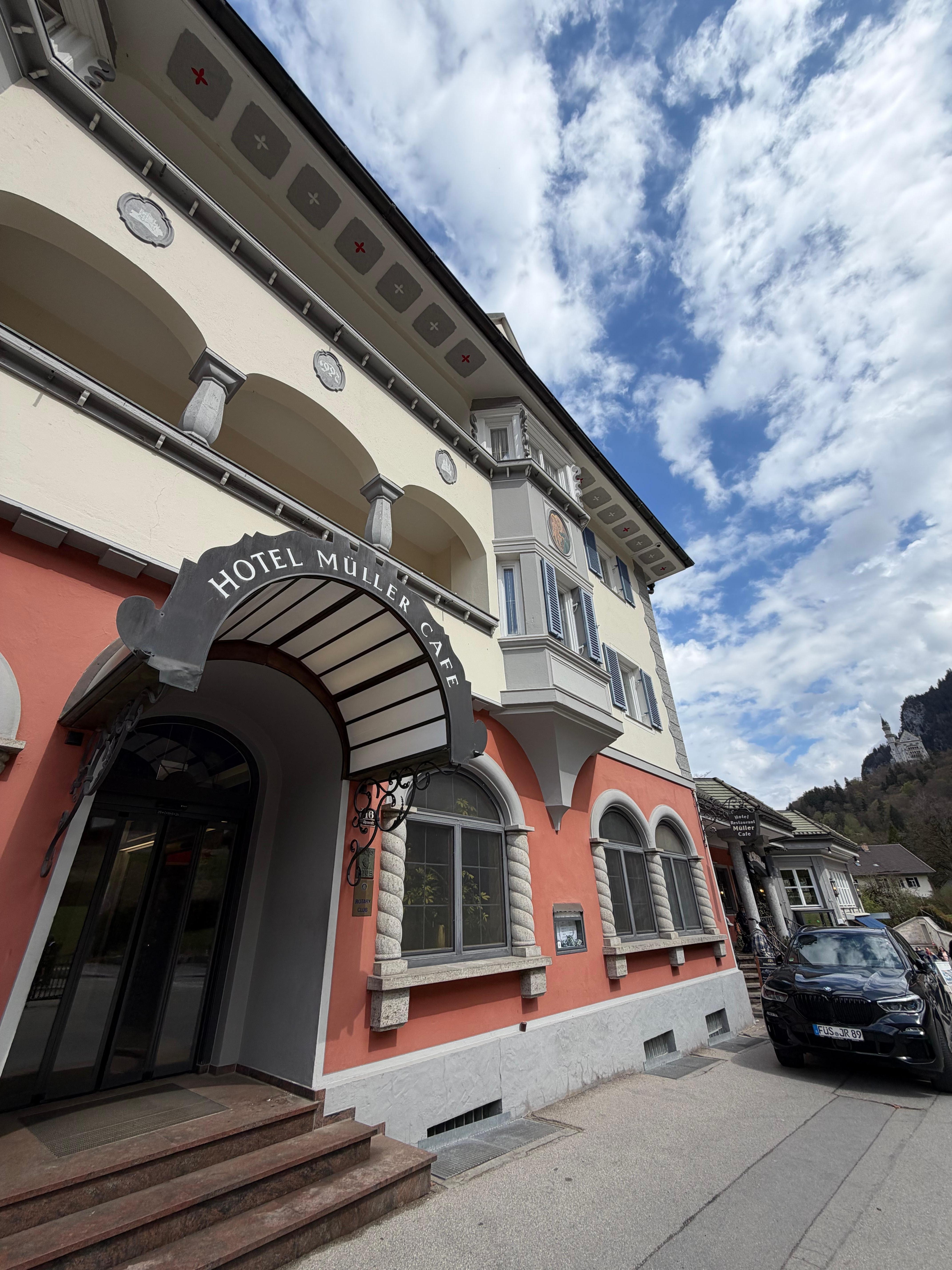 Exterior view with Neuschwanstein overlooking hotel