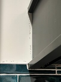 The ant path coming from the top of the stove leading down the cabinet line to the ant traps