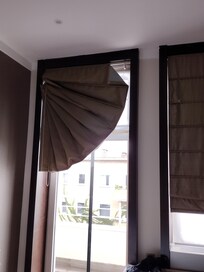 Cleaning ladies shut the balcony door closed on the curtain and it wouldn't go back up or down