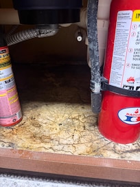 Underneath the sink.