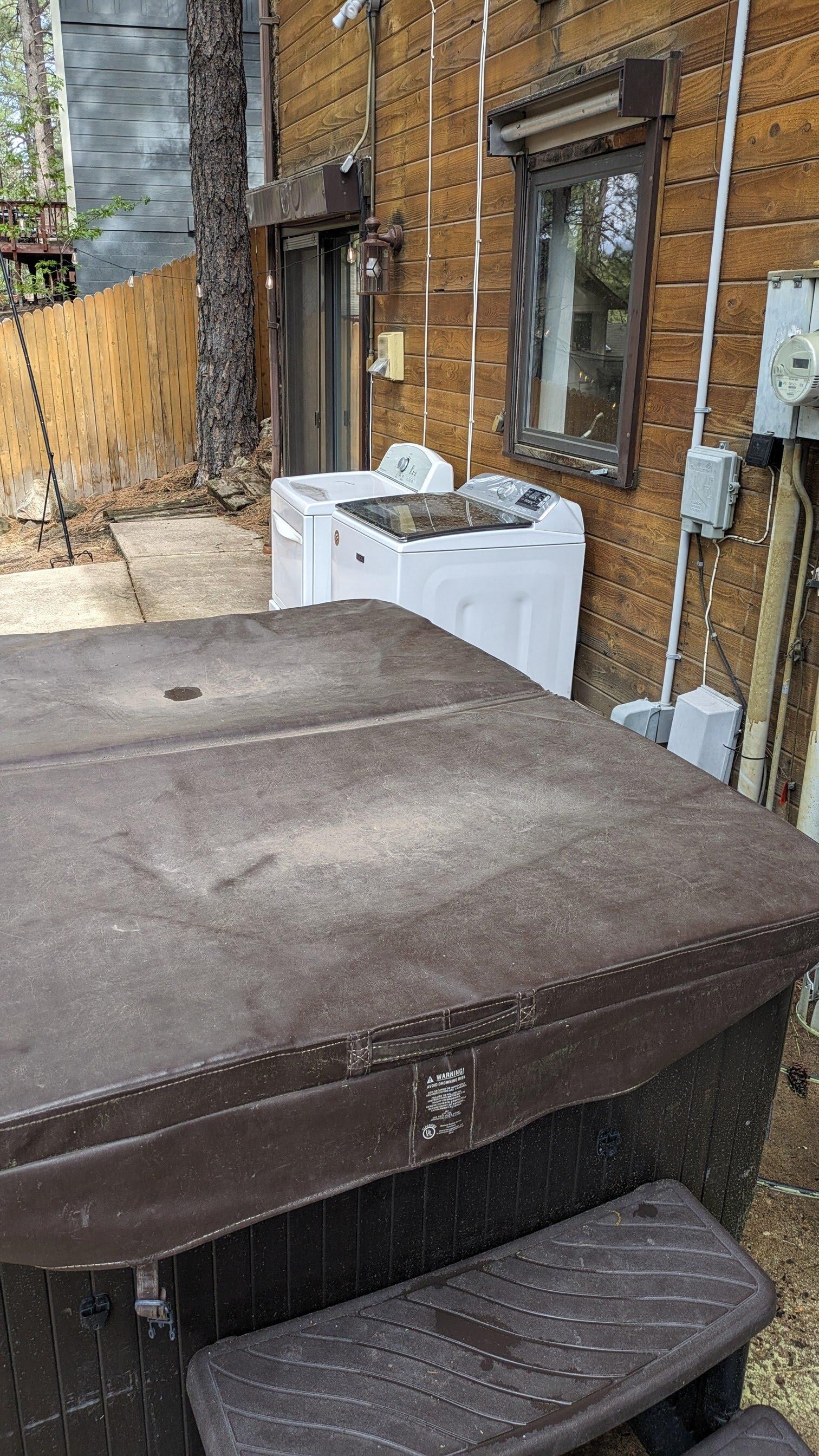 For some awful reason, Glenn installed the washer dryer outside next to hot tub