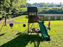Kids playing on the playground at the bottom on the hill