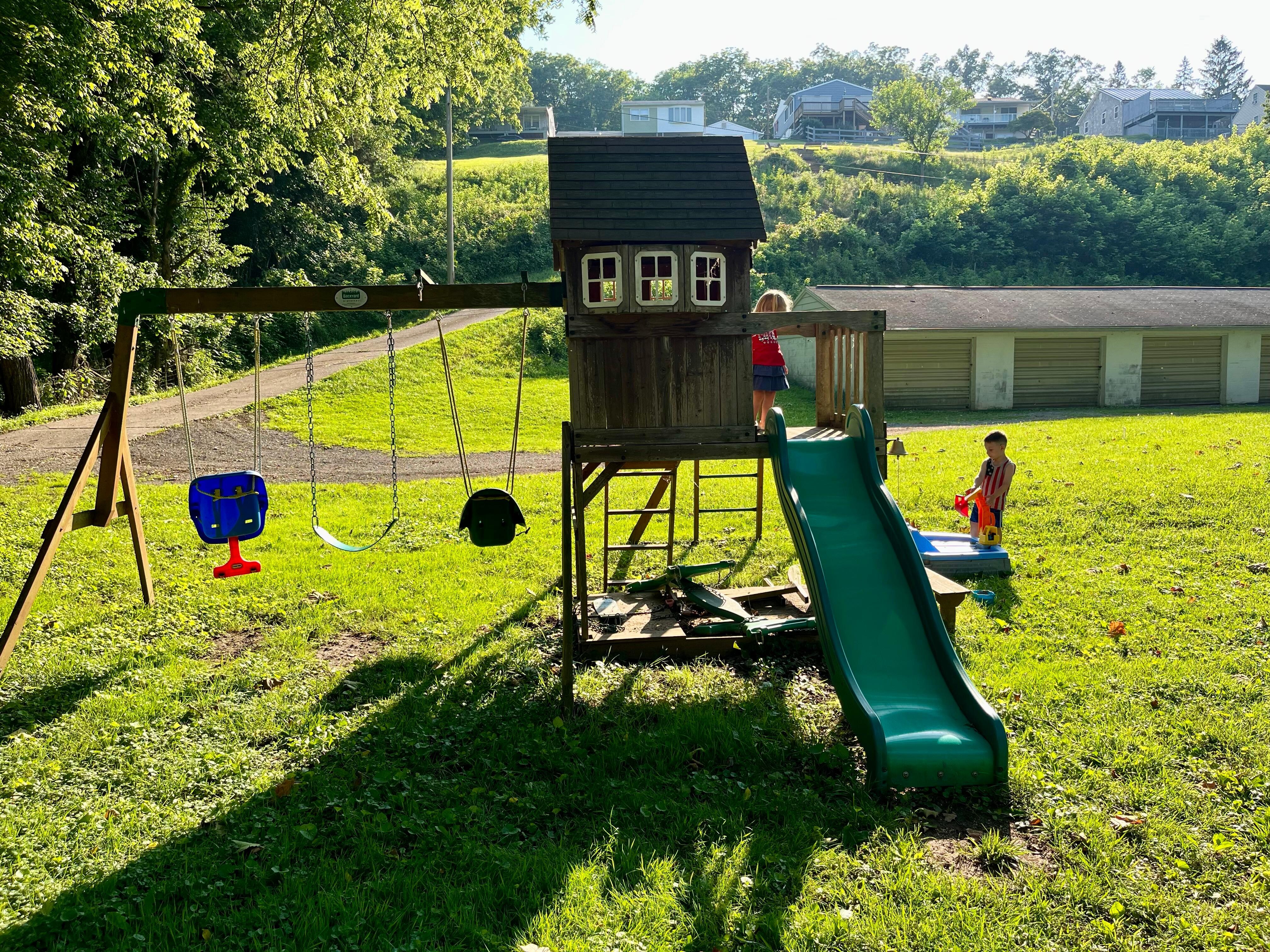 Kids playing on the playground at the bottom on the hill