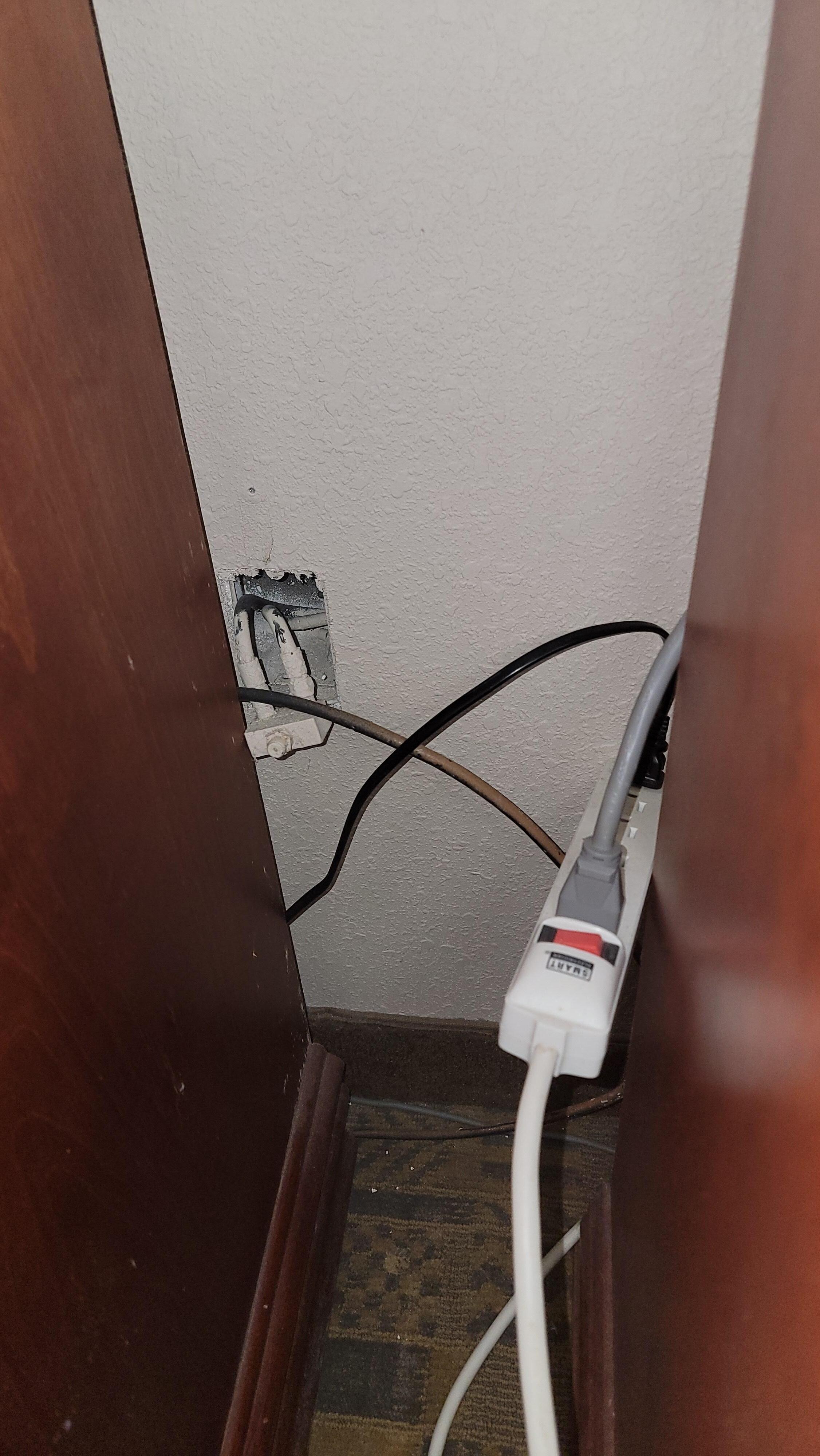 Gang box cover plate not attached.  Haunted, floating power strip.