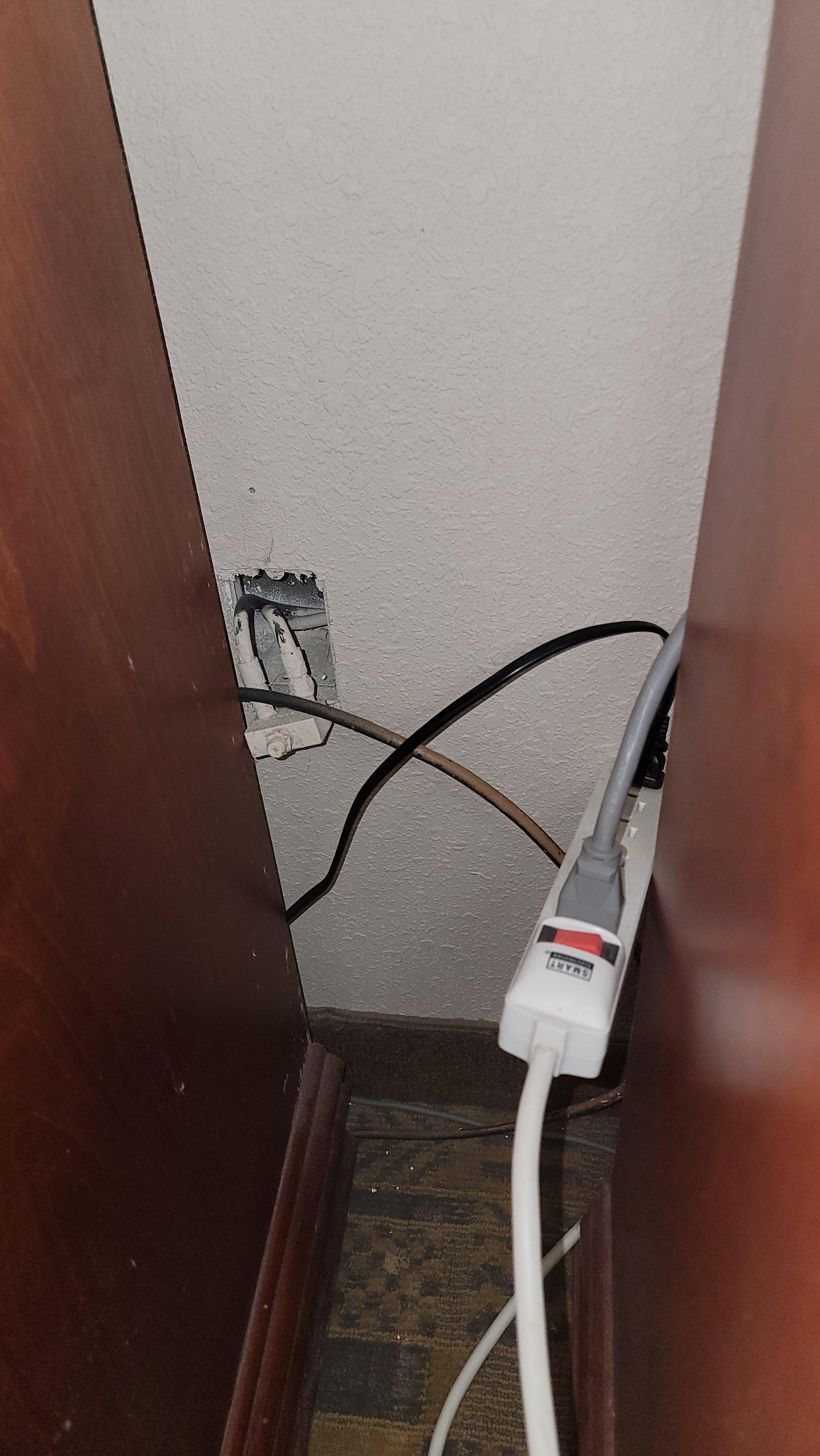 Gang box cover plate not attached. Haunted, floating power strip.