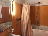 Very old shower. Problem: every tinme the whole bathroom is wet when showering due to some maintenance issues.