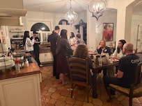 Family from all over the country spending time together around the kitchen table, laughing and telling stories until late into the night.