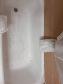 The bathtub must have been painted at some point and the paint was peeling. The tub stopper could not be poured out and so the tub drained slowly during a shower.