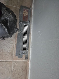 Duct tape secures a register in the floor