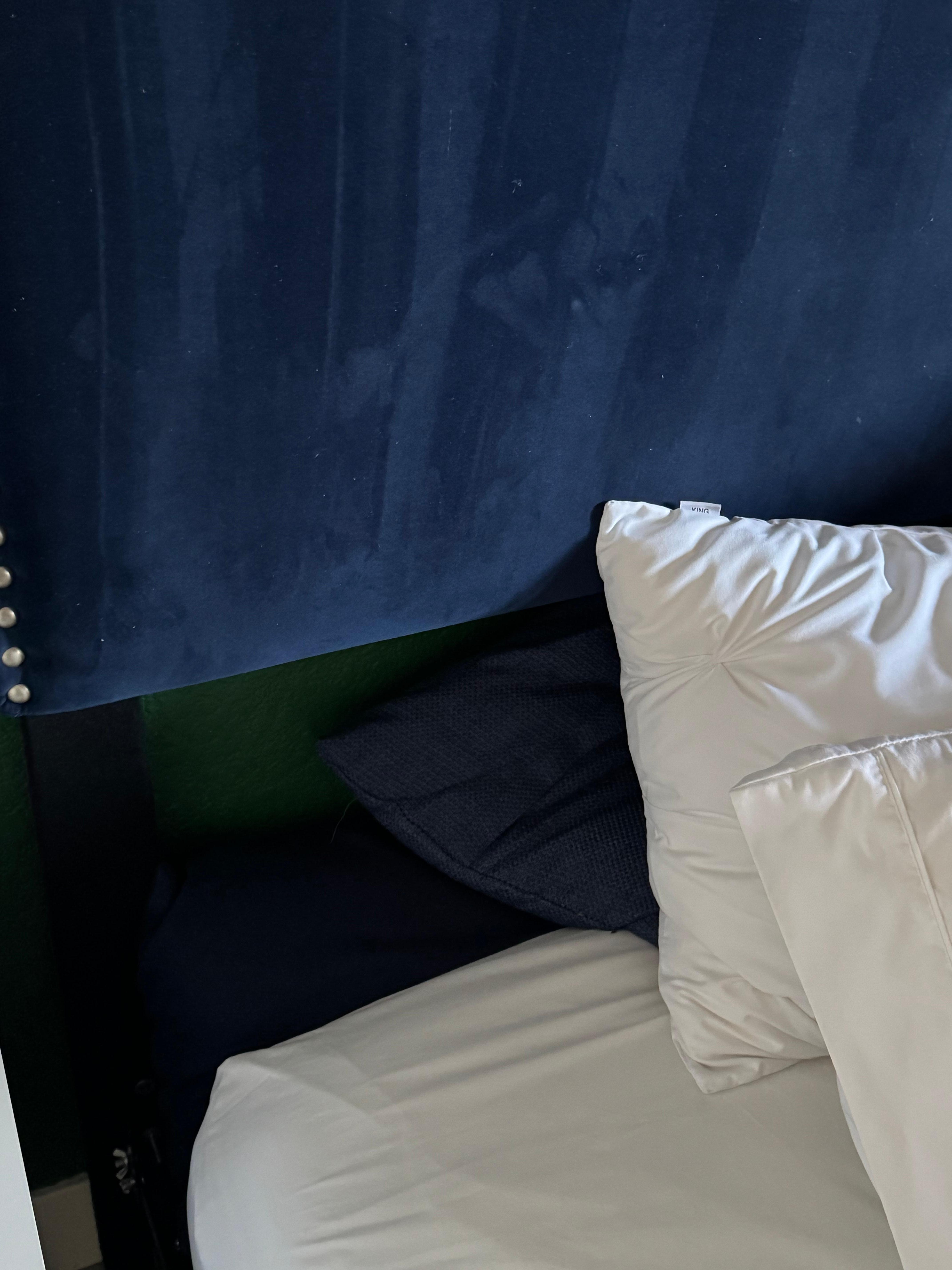 Space between headboard and mattress.  We propped decorative pillows behind to keep pillows from going behind 