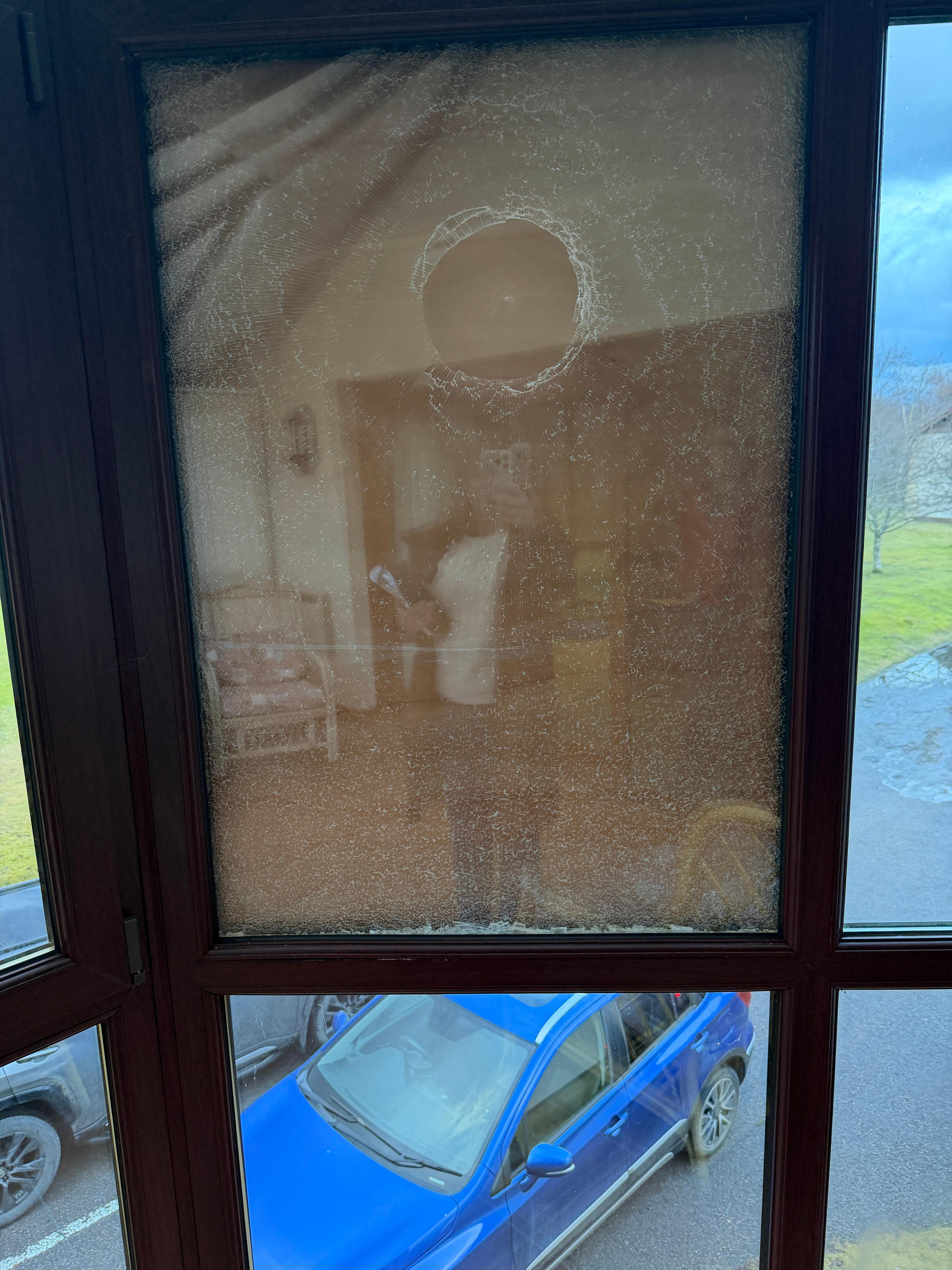 Boarded broken window in conservatory