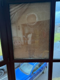 Boarded broken window in conservatory