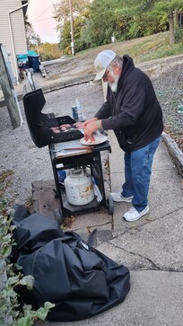 Grilling steaks and potatoes for supper
