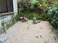 Small gravel yard in front and parking space for 2 cars in front of this space.