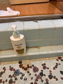 Step into bathroom is as tall as Conditioner bottle