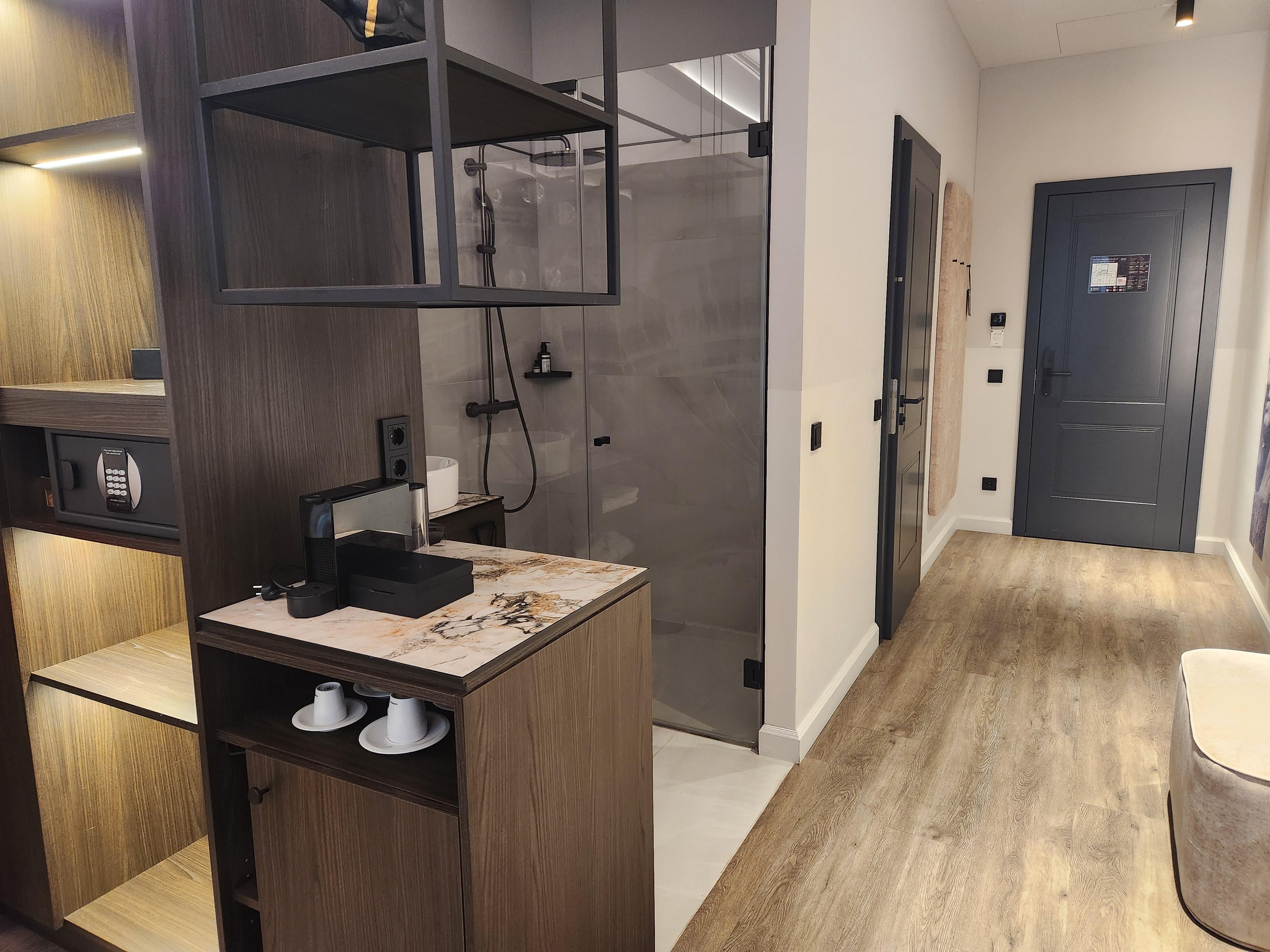 The shower/sink was "open" (right there on the other side of the divider) but the toilet was in it's own room.