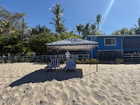 View of the house from the beach. The cabana and beach chairs are for the use of the studio guests.