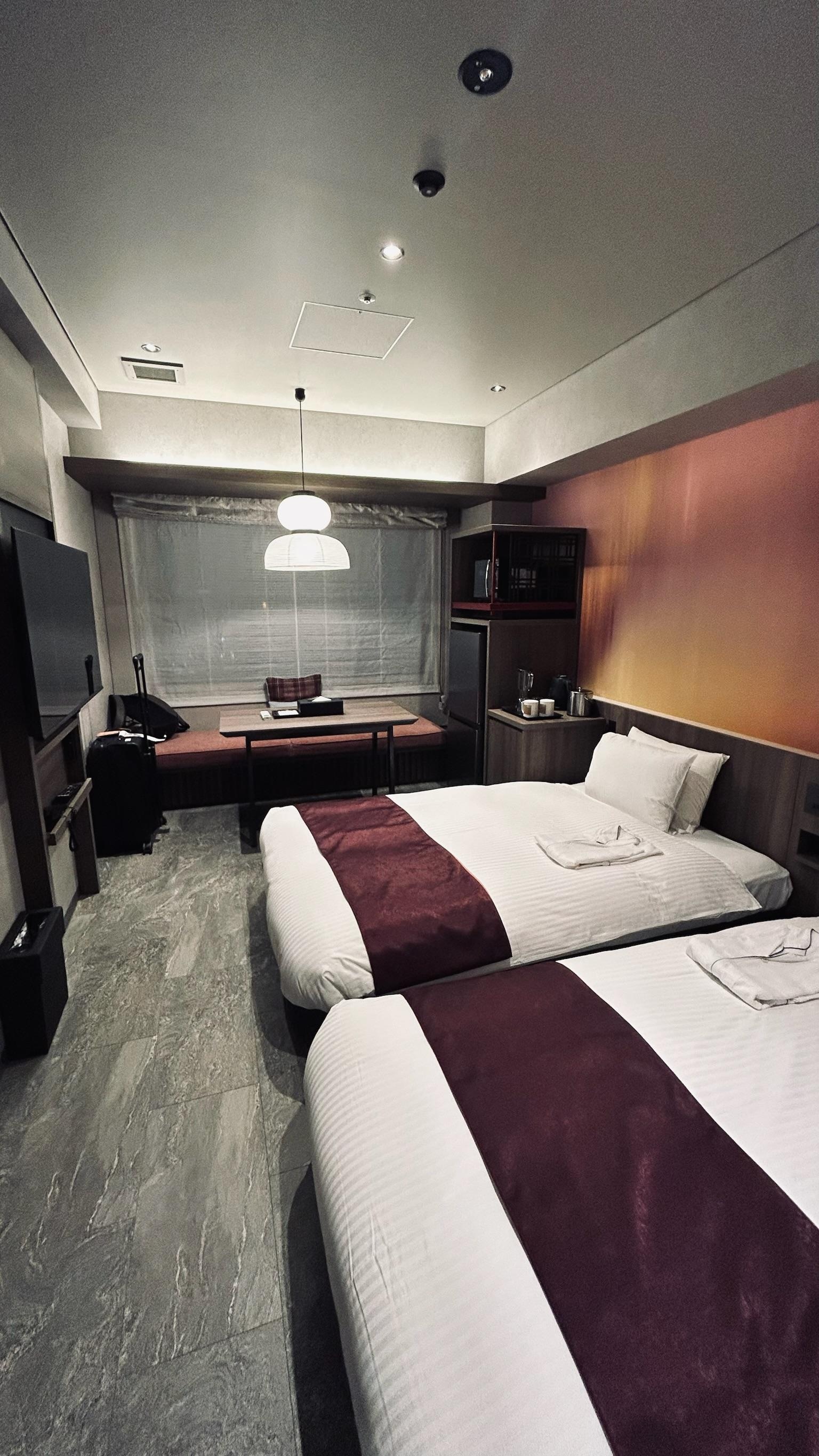 Room is larger than the typical bed-sized rooms in many hotels. Beds are like US twin-and-a-half size