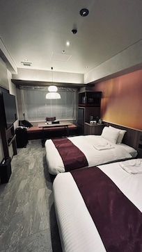 Room is larger than the typical bed-sized rooms in many hotels. Beds are like US twin-and-a-half size