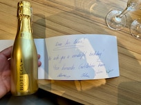 Birthday card signed by the staff and Champaign in my room.