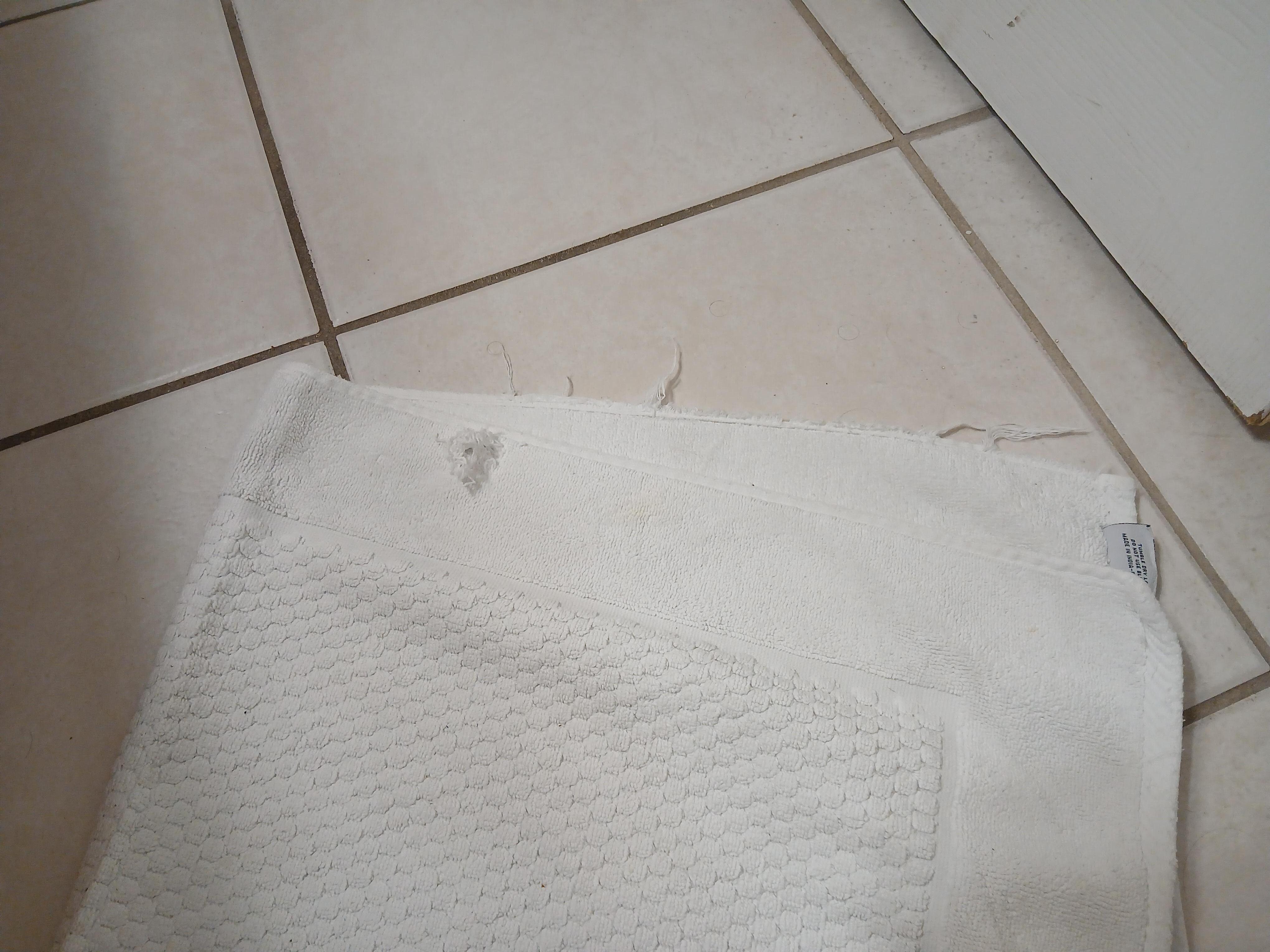 frayed bath mat with hole