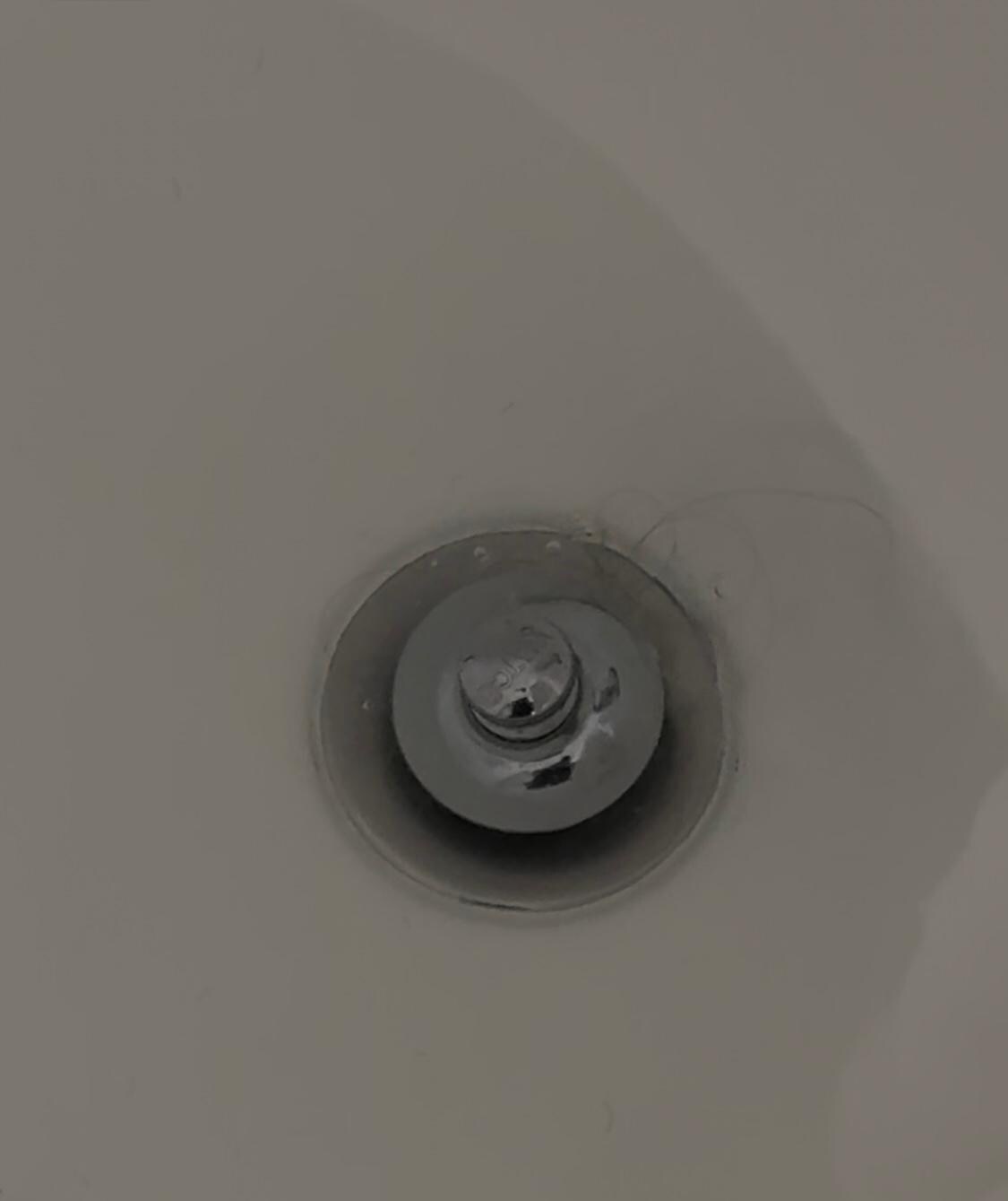 Shower drain clogged and hair stuck in it