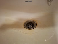 cracked and dirty sink, with filthy plughole