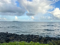 View from the infinity pool in the waterpark of the ocean with a rainbow