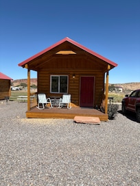 Adorable cabin with front porch for evening sitting.