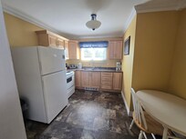 Kitchen with full size fridge and stove