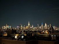 Nighttime view from the rooftop deck looking uptown