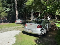 Cars full of trash in the driveway