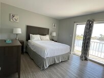 Bedroom with balcony overlooking the small lake