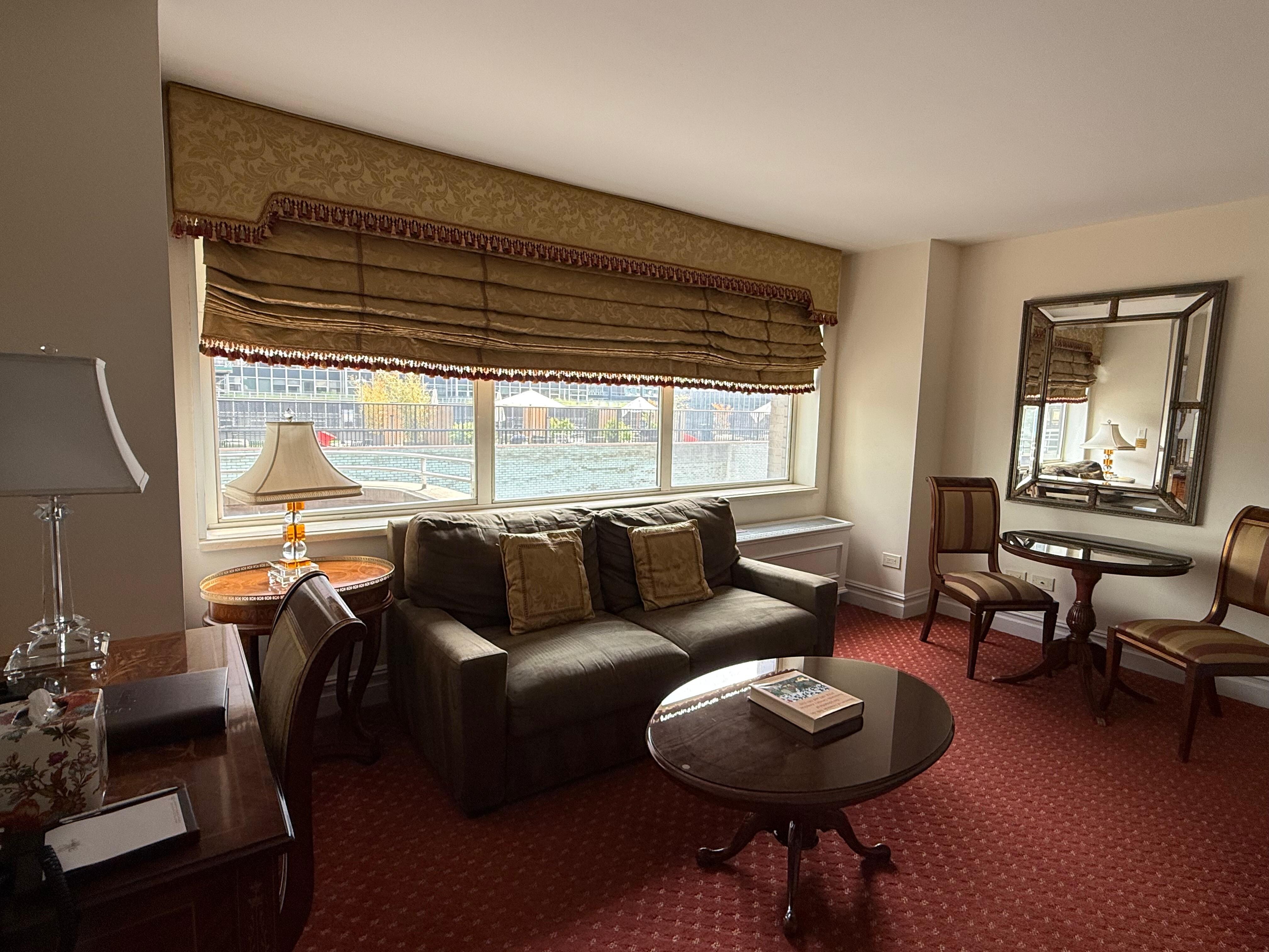 Living room with large screen tv and table for 2. Bar area with little refrigerator and coffeemaker. 