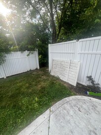 Section of broken fence surrounding pool