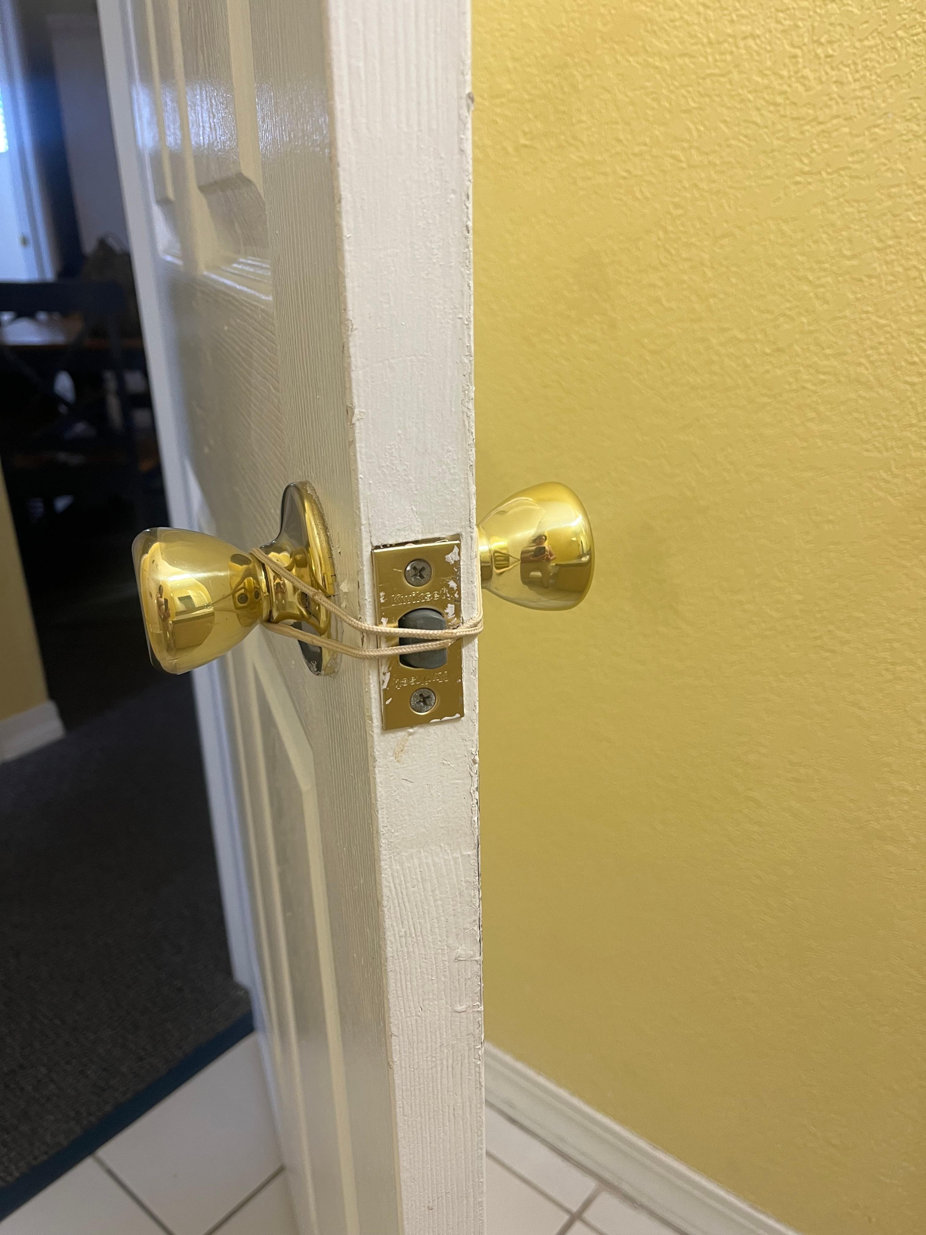 I used a hair tie to keep the door from locking one in. 