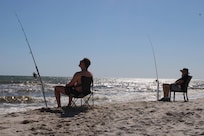 Grandfather and grandson fishing.