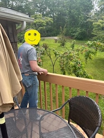 Nice deck, clean grill, and a tree loaded with peaches.
