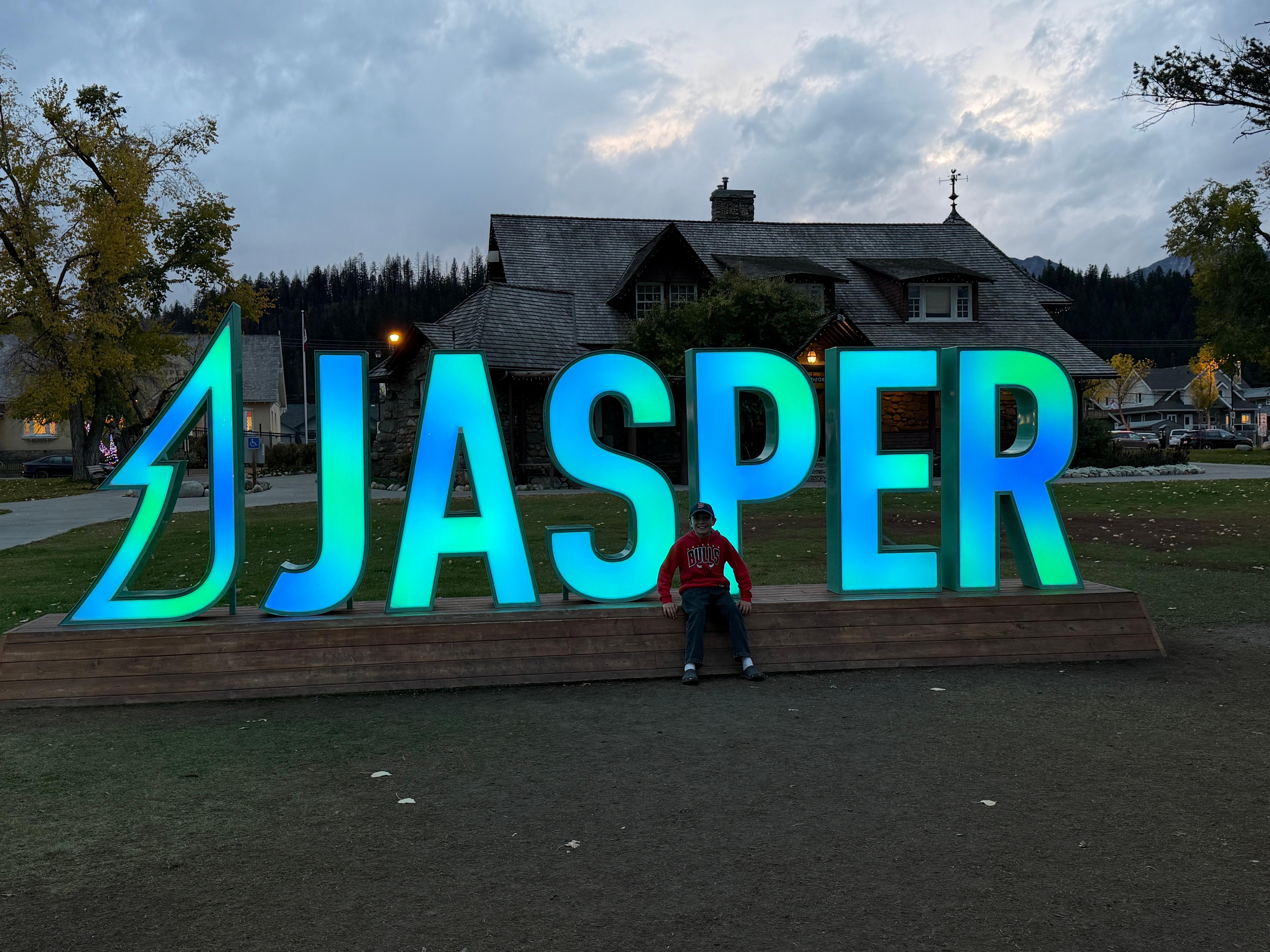 Town sign lights up at night 