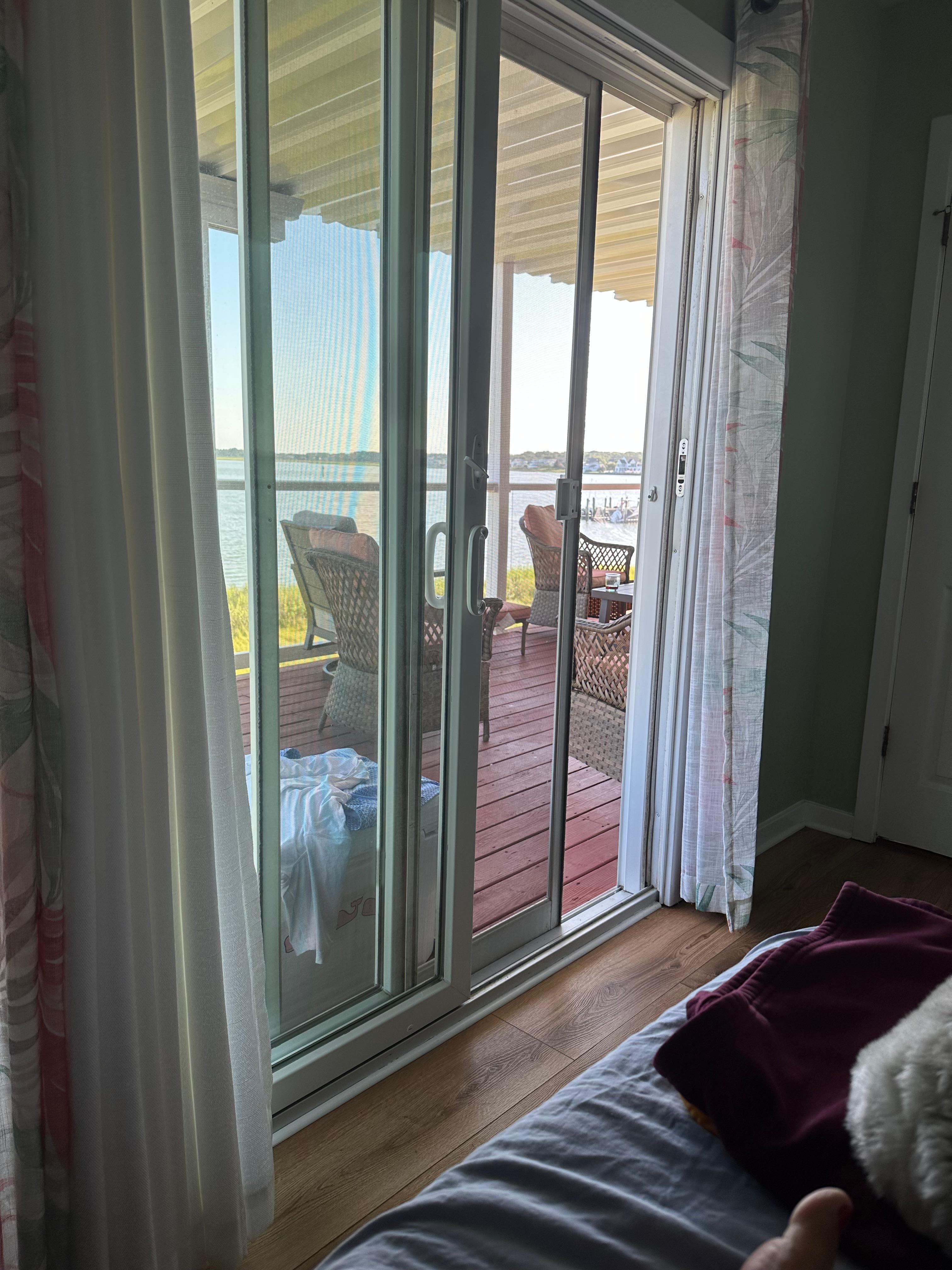 View from room with queen bed looking out onto covered deck