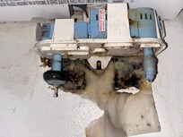 Condensation pump with visible wet paper towel behind the unit and mold.